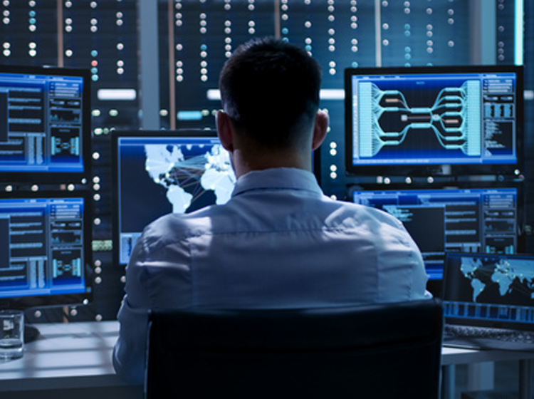CFO using AI and machine learning on multiple monitors for business growth