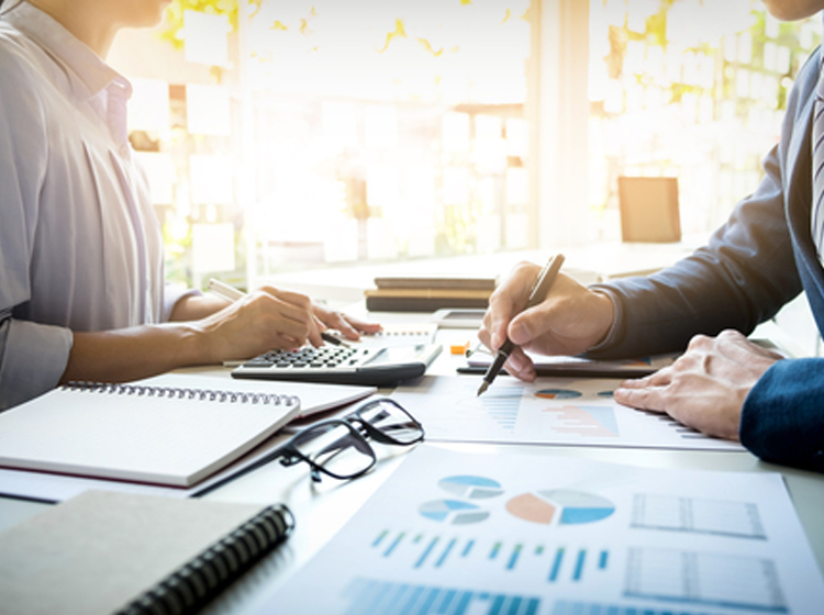 CFOs reviewing financial reports and R&D tax credit documents with managed IT services.