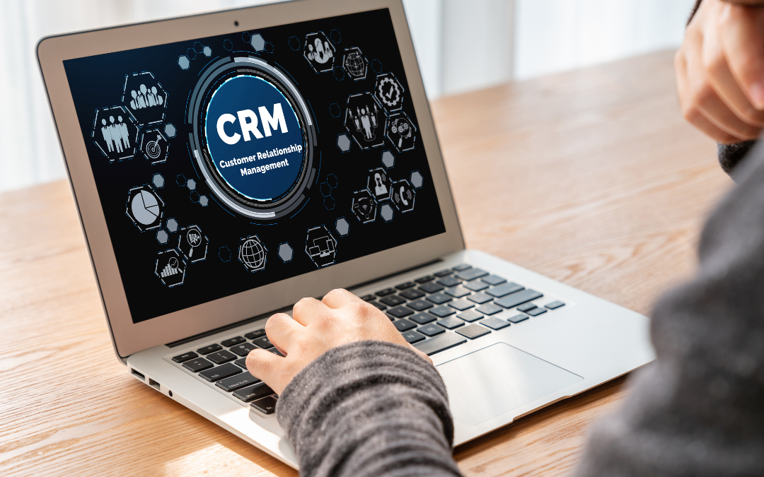 Laptop screen displaying CRM Customer Relationship Management with icons.